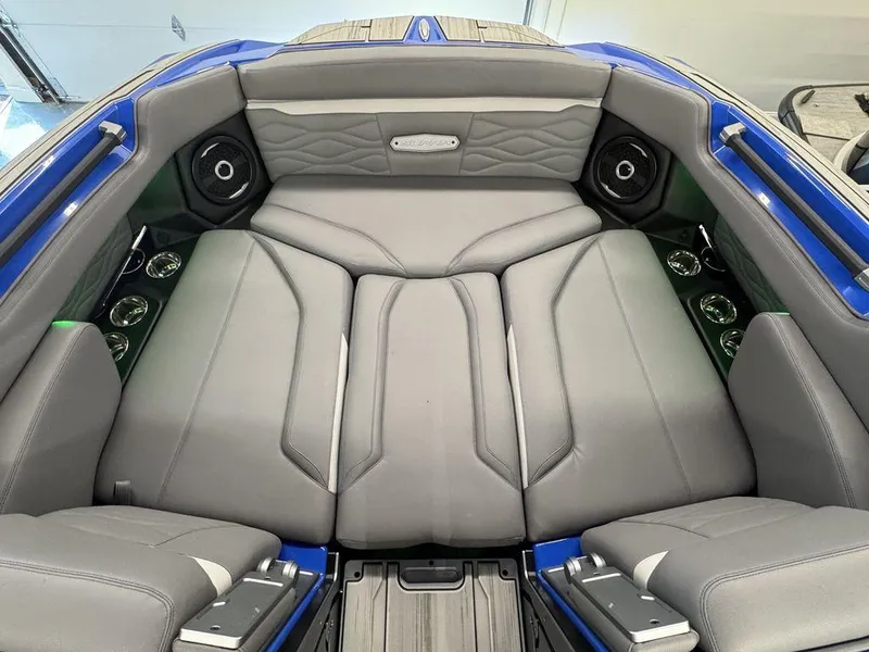 Slide: The Image of Interior of 2025 Supra SA 450 boat with luxurious gray seating and speakers. - 21