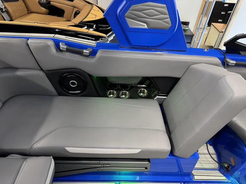 Slide: The Image of 2025 Supra SA 450 boat interior with gray seating and blue accents. - 24