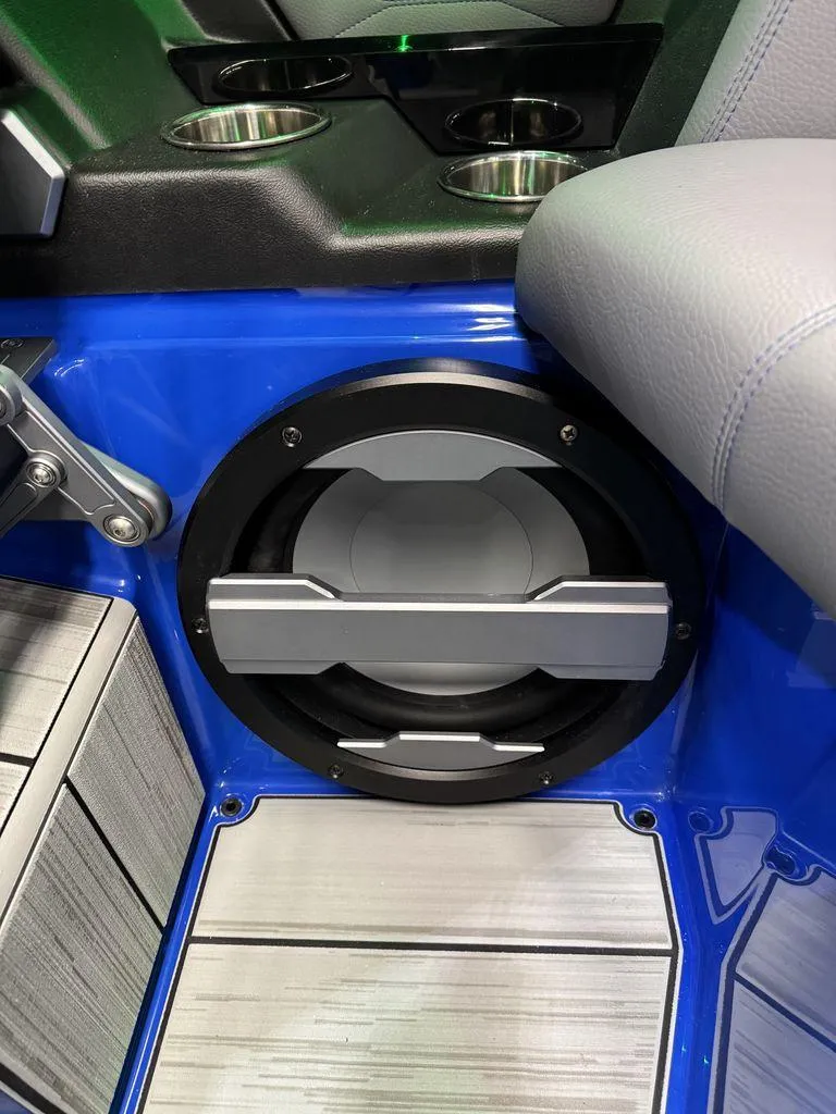 Slide: The Image of 2025 Supra SA 450 interior with speaker and cup holders, featuring blue and gray accents. - 25