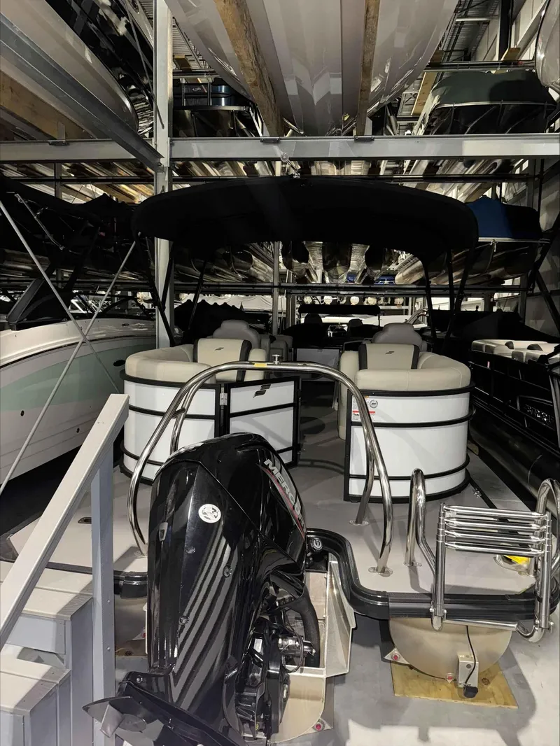 Slide: The Image of 2022 Starcraft EXS 3 pontoon boat in storage facility. - 3