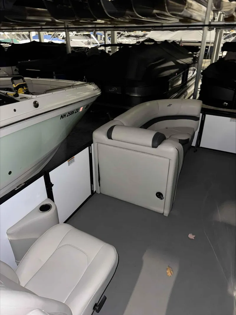 Slide: The Image of 2022 Starcraft EXS 3 boat interior with white seating in storage facility. - 5