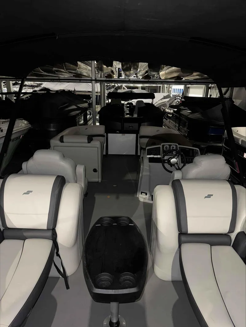 Slide: The Image of 2022 Starcraft EXS 3 boat interior with plush seating and modern dashboard. - 6