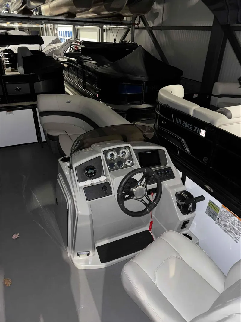 Slide: The Image of 2022 Starcraft EXS 3 boat interior with steering console and seating. - 7