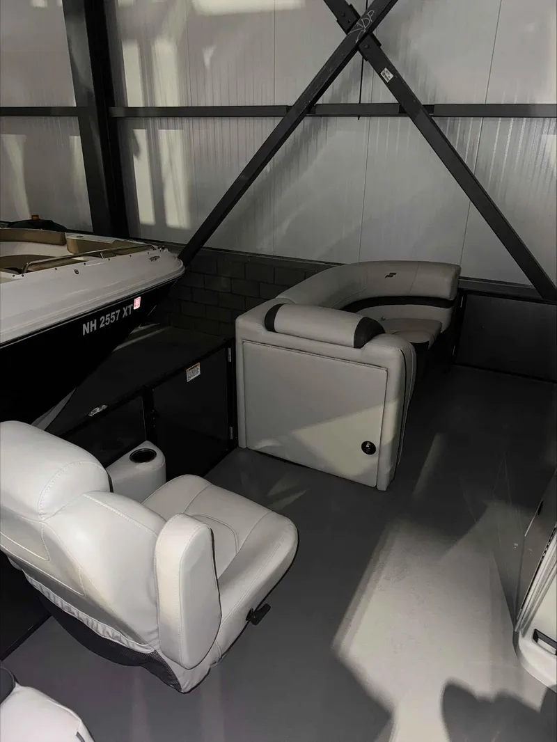 Slide: The Image of 2022 Starcraft EXS 3 boat interior with white seating in storage. - 3