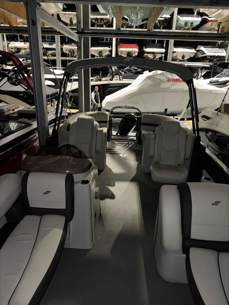 Slide: The Image of 2022 Starcraft EXS 3 boat interior in storage facility with multiple boats. - 7