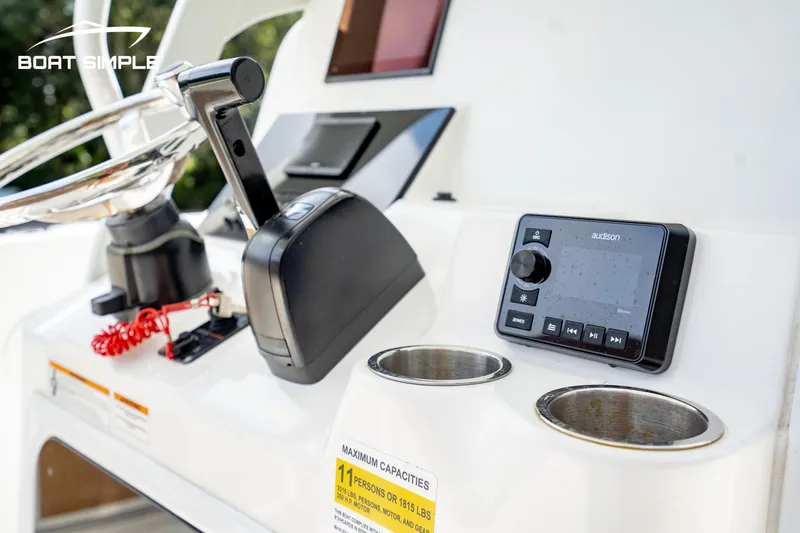 Slide: The Image of 2024 Sea Pro 239 Deep V CC boat console with controls and cup holders. - 10