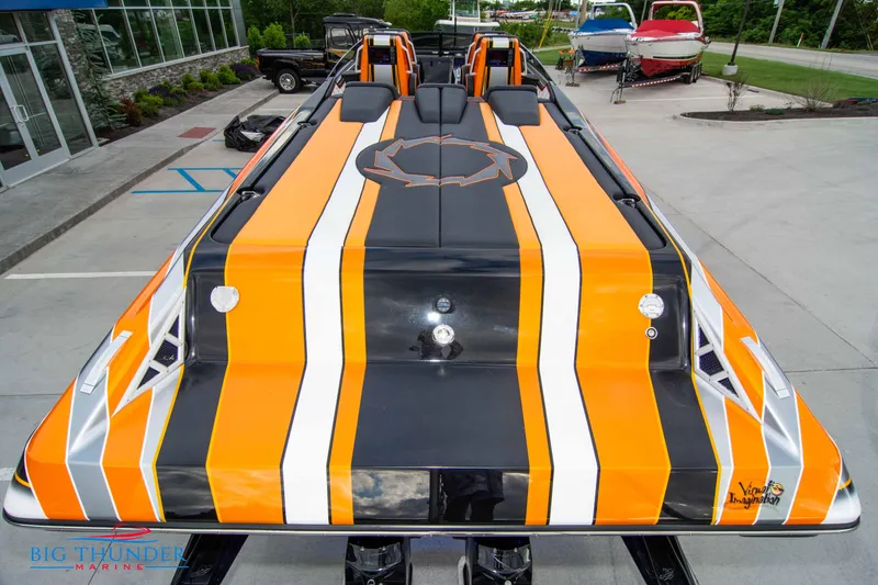 Slide: The Image of 2020 Fountain 47 Lightning boat with bold orange, black, and white stripes. - 14