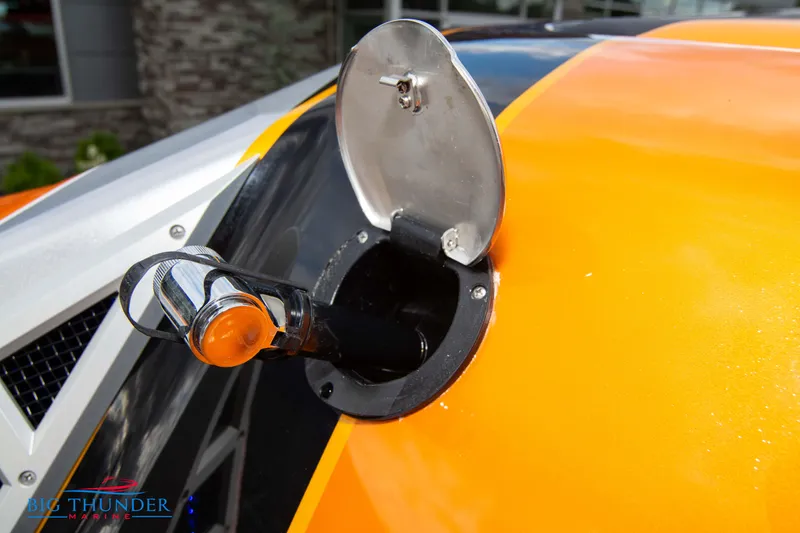 Slide: The Image of Fuel cap of 2020 Fountain 47 Lightning boat with orange and black design. - 15