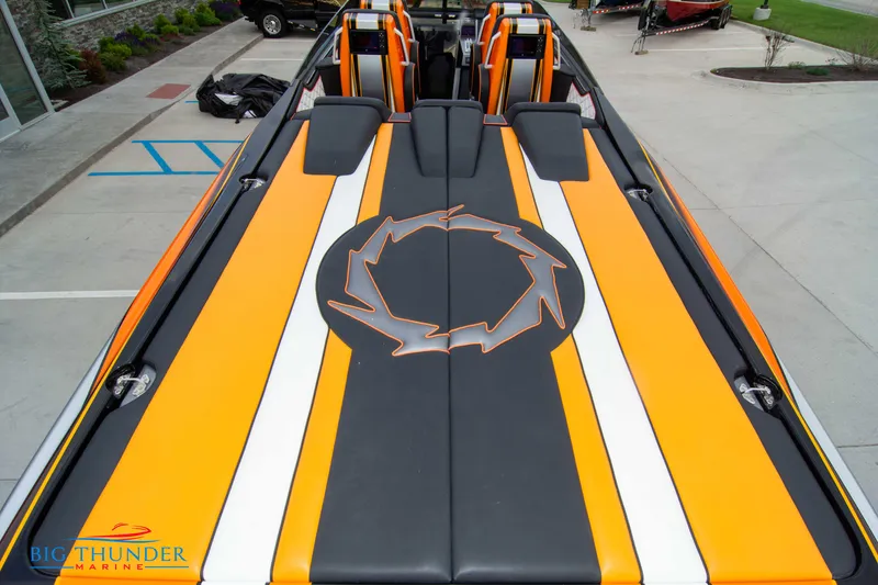 Slide: The Image of 2020 Fountain 47 Lightning boat with vibrant orange and black design, docked at marina. - 17