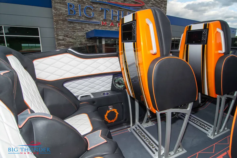 Slide: The Image of 2020 Fountain 47 Lightning boat interior with orange and white seating at Big Thunder Marina. - 22