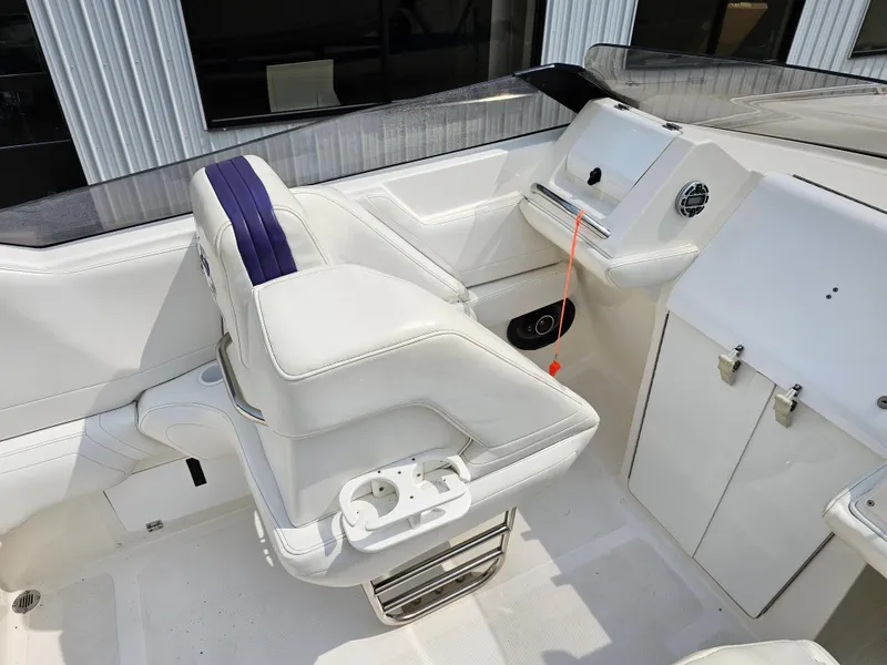 Slide: The Image of 1999 Fountain 29 Fever boat interior with white seating and dashboard. - 12