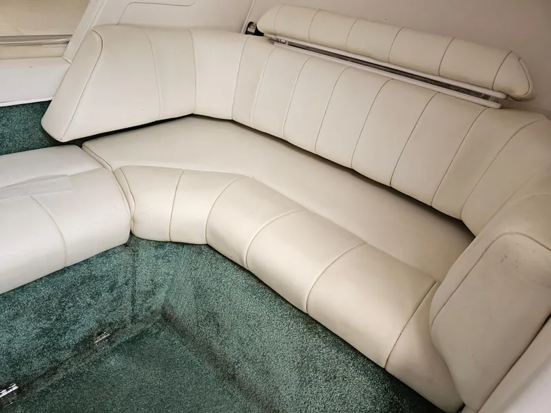 Slide: The Image of 1999 Fountain 29 Fever boat interior with white leather seating and green carpet. - 14