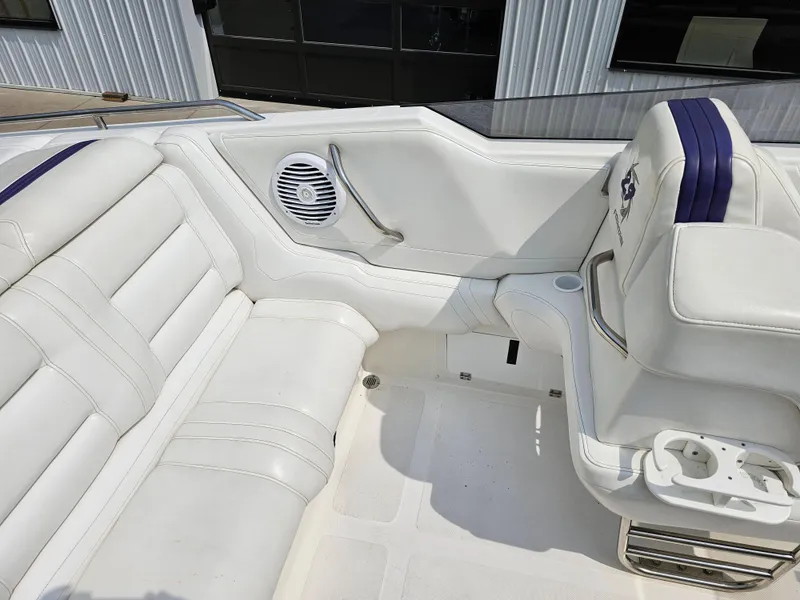 Slide: The Image of 1999 Fountain 29 Fever boat interior with white leather seating and speaker. - 15