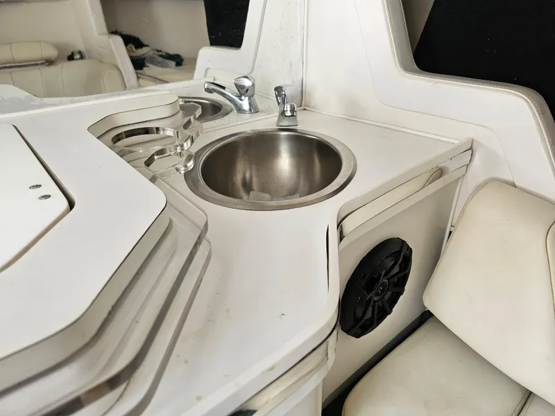 Slide: The Image of 1999 Fountain 29 Fever boat interior with sink and seating area. - 21