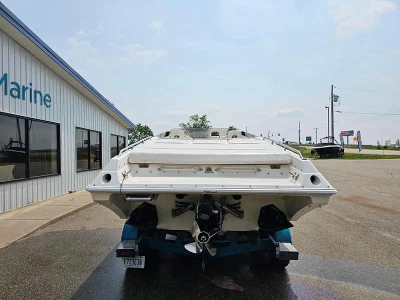 Slide: The Image of Rear view of a 1999 Fountain 29 Fever boat outside a marine shop. - 3