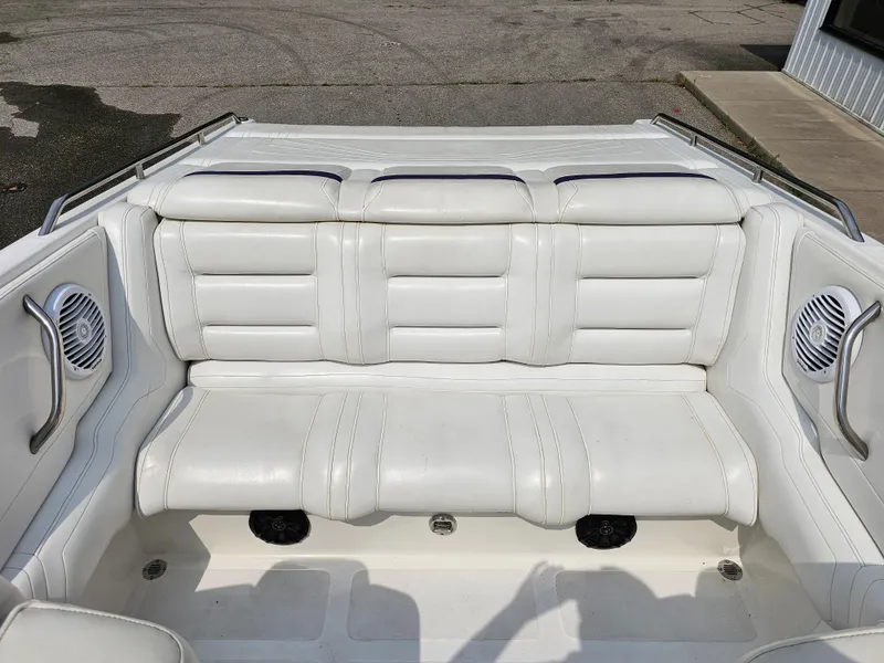 Slide: The Image of 1999 Fountain 29 Fever boat interior with white leather seating and built-in speakers. - 8