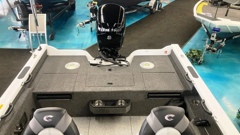 Slide: The Image of 2025 Crestliner 1850 Fish Hawk WT JS boat interior with motor and seating. - 1