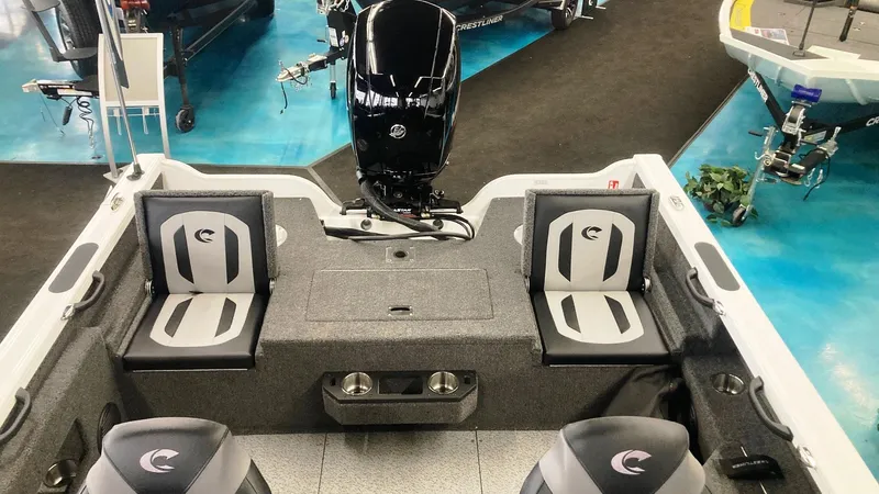 Slide: The Image of 2025 Crestliner 1850 Fish Hawk WT JS boat interior with seating and motor. - 2