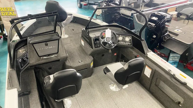 Slide: The Image of 2025 Crestliner 1850 Fish Hawk WT JS boat interior with seating and control panel. - 5