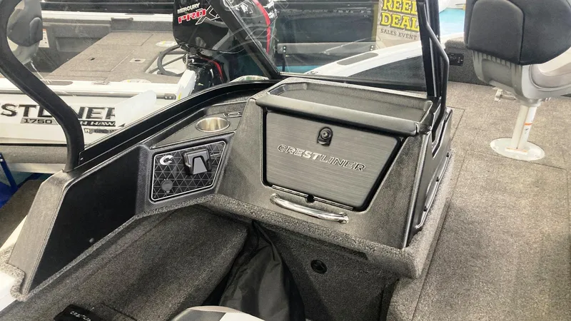 Slide: The Image of 2025 Crestliner 1850 Fish Hawk WT JS interior with storage compartment and seating. - 7