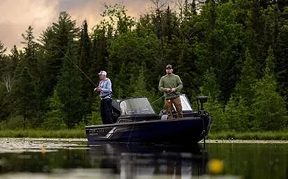 Slide: The Image of Two people fishing on a 2025 Crestliner 1850 Fish Hawk WT JS boat in a serene lake. - 9