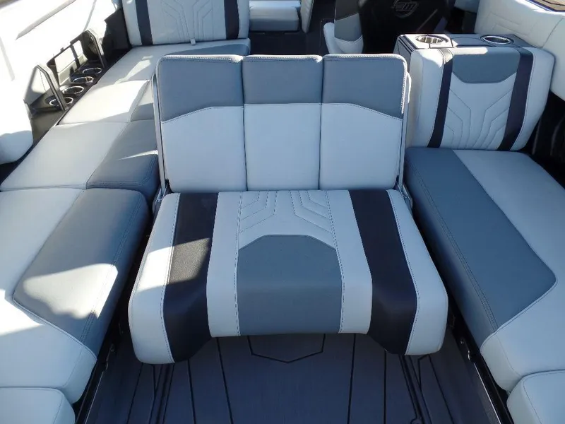 Slide: The Image of 2025 Malibu 25 LSV boat interior with modern gray and black seating design. - 11