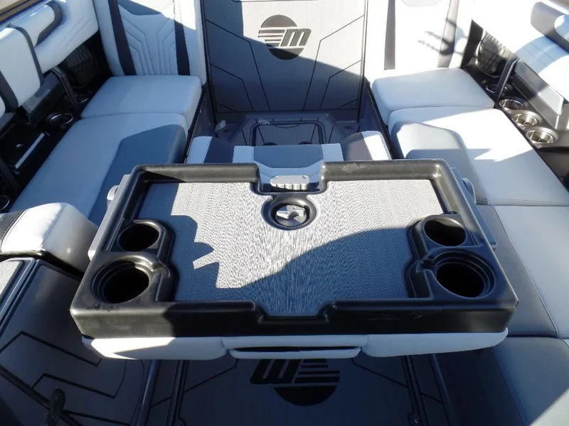 Slide: The Image of Interior of 2025 Malibu 25 LSV boat with seating and cup holders. - 12