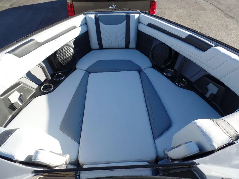 Slide: The Image of 2025 Malibu 25 LSV boat interior with luxurious seating and cup holders. - 17