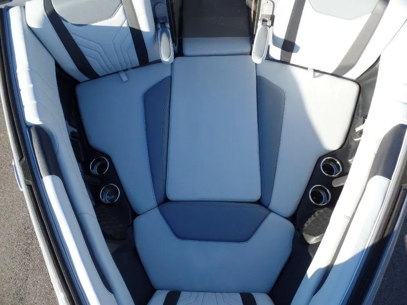 Slide: The Image of 2025 Malibu 25 LSV boat interior seating with cup holders, featuring sleek, modern design. - 18