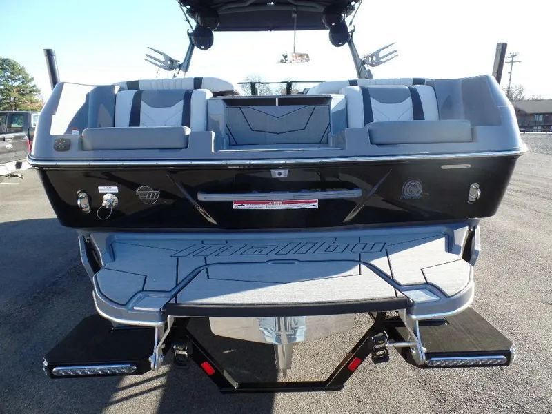 Slide: The Image of 2025 Malibu 25 LSV boat, rear view with seating and swim platform. - 3