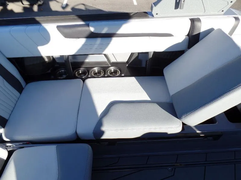 Slide: The Image of 2025 Malibu 25 LSV boat interior with sleek seating and cup holders. - 5