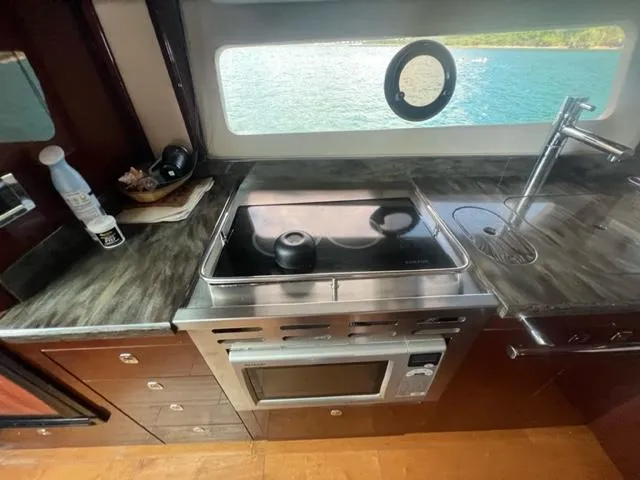 Slide: The Image of Luxurious kitchen interior of 2012 Sea Ray 500 Sundancer yacht with ocean view. - 19