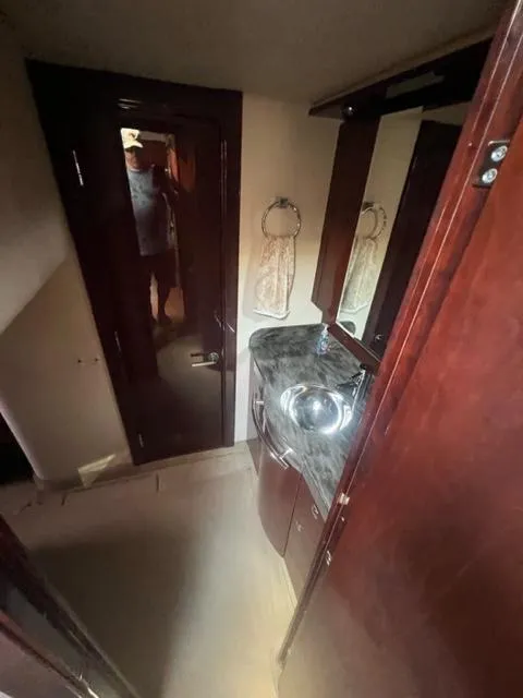 Slide: The Image of Interior of 2012 Sea Ray 500 Sundancer bathroom with sink and mirror. - 21