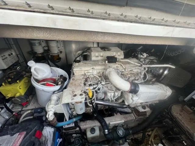 Slide: The Image of Engine compartment of 2012 Sea Ray 500 Sundancer with visible components and tools. - 25