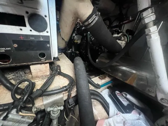 Slide: The Image of Engine room of 2012 Sea Ray 500 Sundancer with visible hoses and wiring. - 32