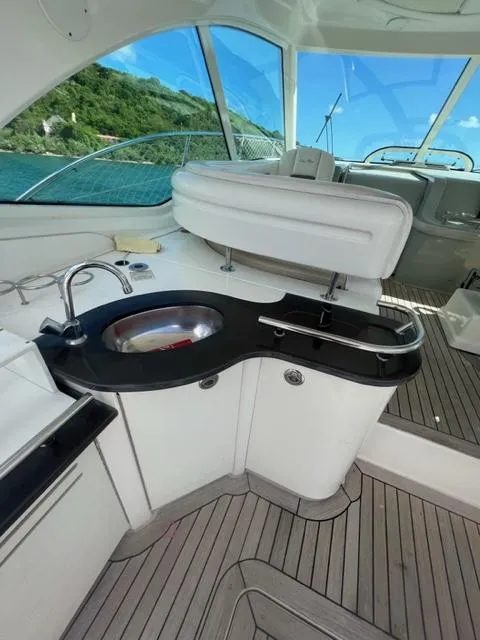 Slide: The Image of Luxurious 2012 Sea Ray 500 Sundancer yacht interior with sleek kitchenette and scenic ocean view. - 7