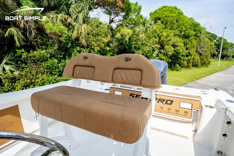 Slide: The Image of 2024 Sea Pro 239 Deep V CC boat seat with lush greenery background. - 7