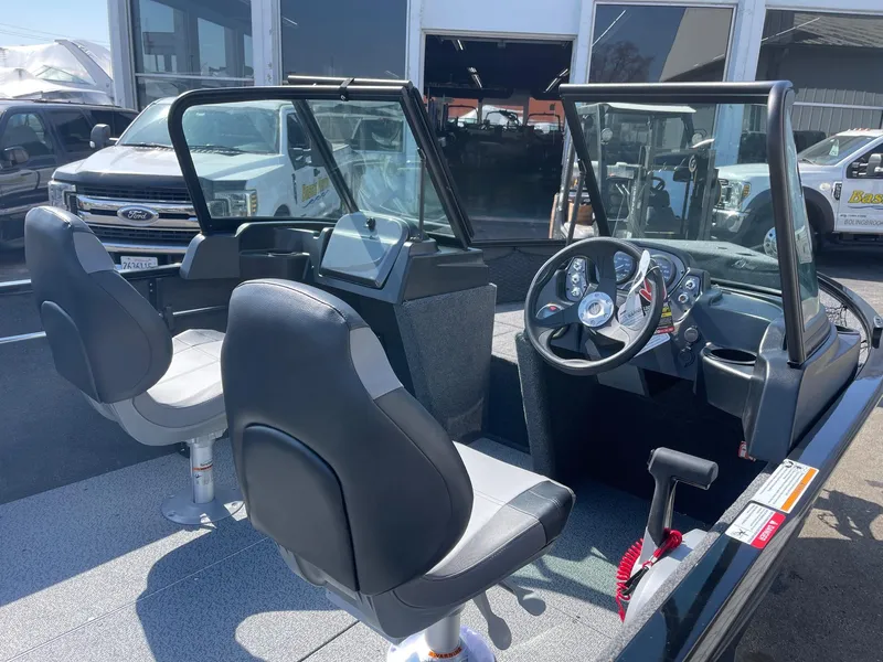 Slide: The Image of 2025 Crestliner 1650 KODIAK WT boat interior with dual seats and steering console. - 2