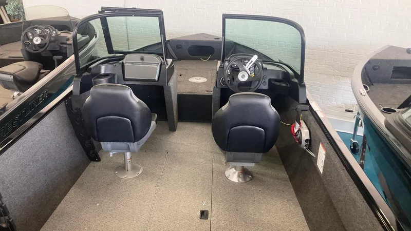 Slide: The Image of 2025 Crestliner 1650 KODIAK WT interior with dual seats and steering console. - 3