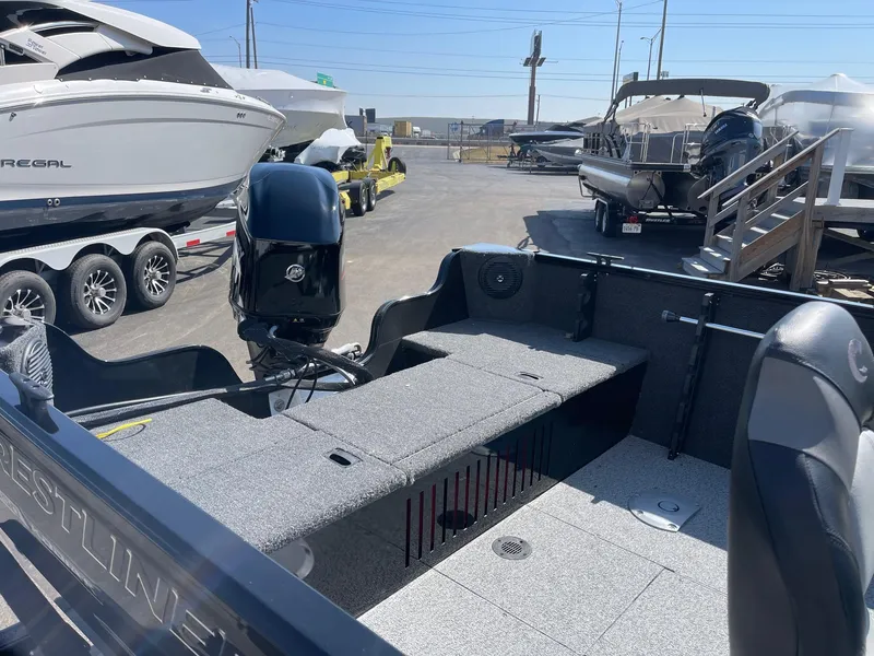 Slide: The Image of 2025 Crestliner 1650 KODIAK WT boat interior at a marina, showcasing seating and motor. - 5