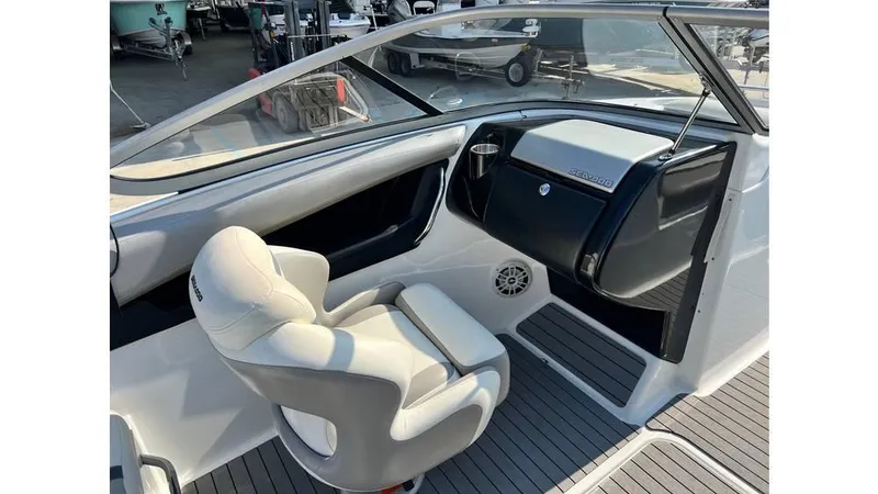 Slide: The Image of Interior of 2012 Sea-Doo 230 Challenger SE boat, featuring sleek seating and dashboard. - 7