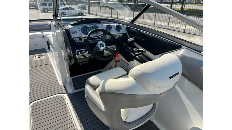 Slide: The Image of 2012 Sea-Doo 230 Challenger SE cockpit with steering wheel and dashboard controls. - 8