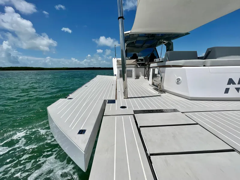 Slide: The Image of 2021 OKEAN 55 Sport yacht on turquoise water under clear blue sky. - 23