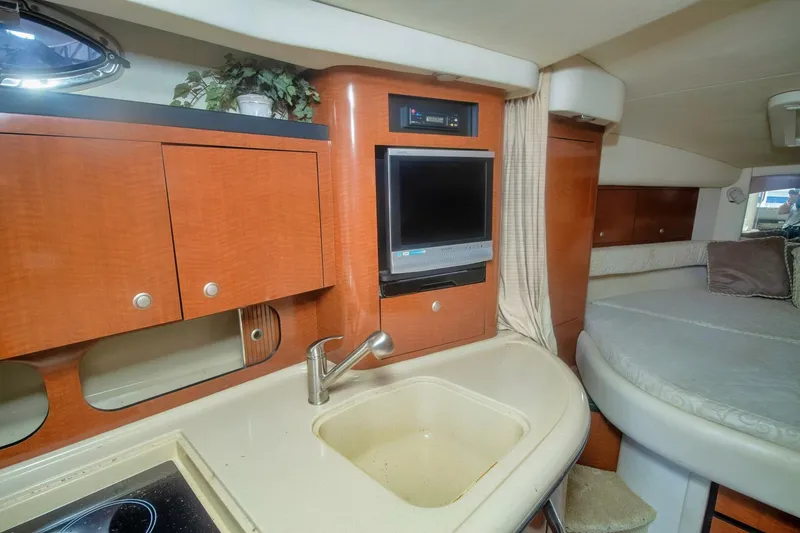 Slide: The Image of Interior of 2005 Sea Ray 340 Sundancer with kitchenette and cozy sleeping area. - 12