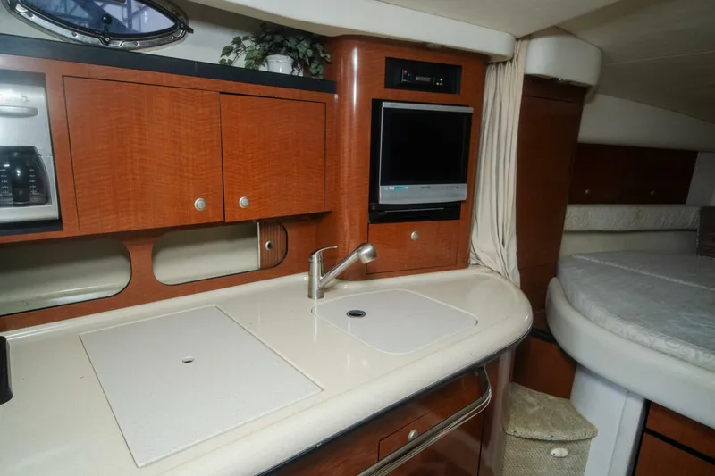 Slide: The Image of 2005 Sea Ray 340 Sundancer interior with kitchenette and bed. - 13