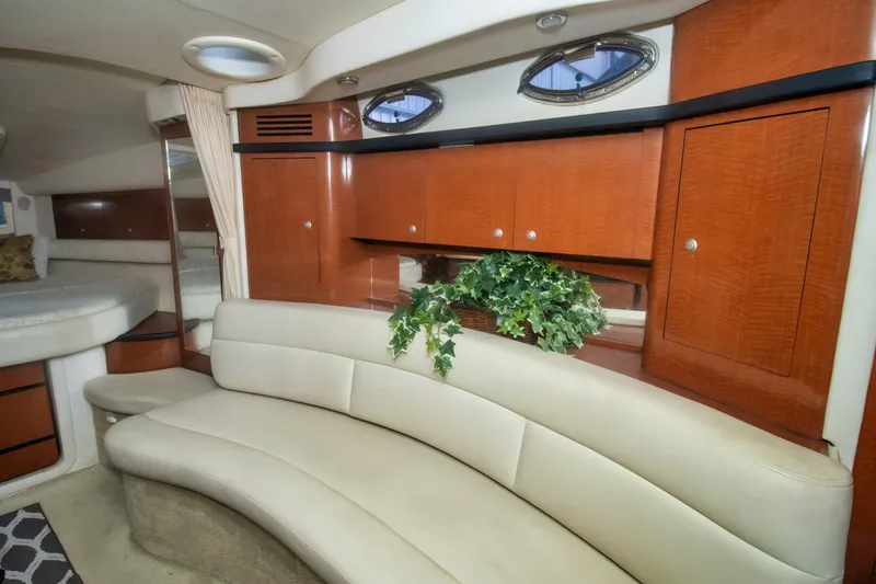 Slide: The Image of Luxurious interior of 2005 Sea Ray 340 Sundancer with curved seating and wood cabinetry. - 14
