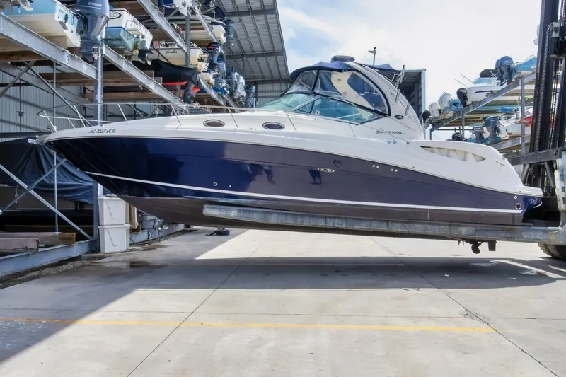 The Image of 2005 Sea Ray 340 Sundancer boat in dry dock storage. - 2