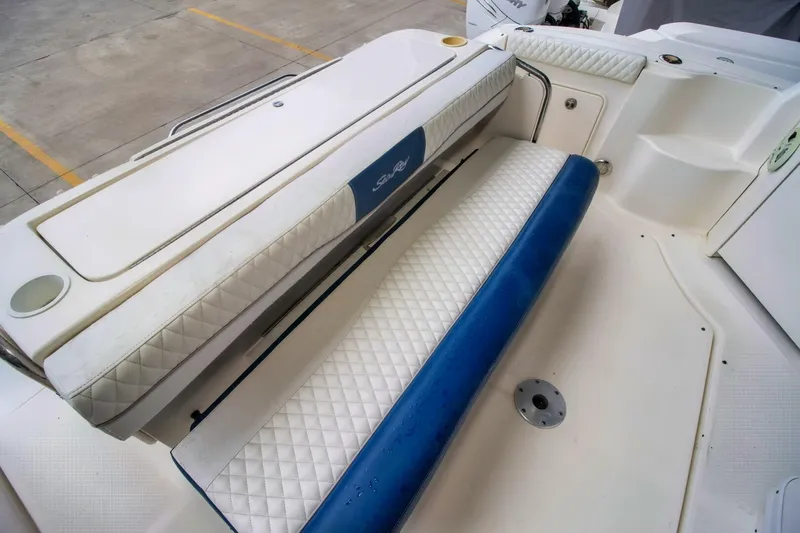 Slide: The Image of 2005 Sea Ray 340 Sundancer boat seating area with white and blue upholstery. - 6