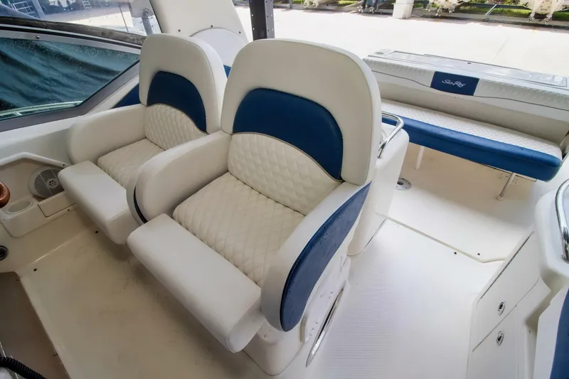 Slide: The Image of 2005 Sea Ray 340 Sundancer interior with plush white and blue seating. - 8