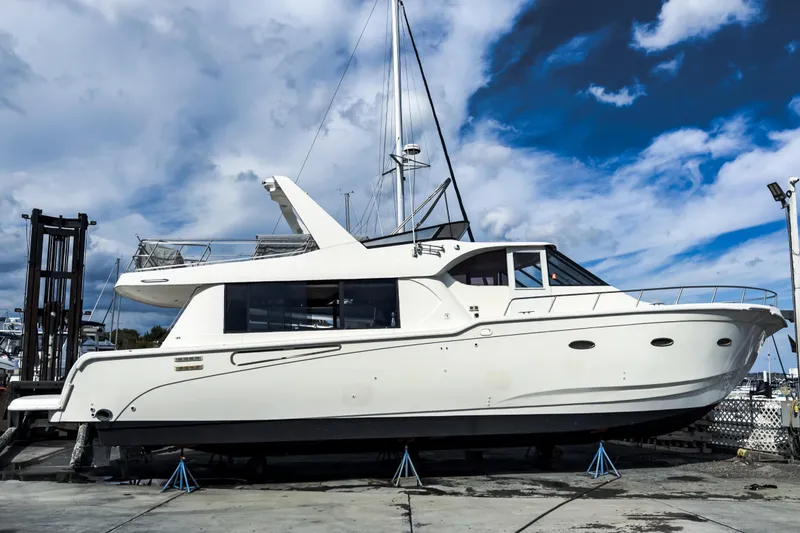 The Image of White Sandpiper 50 yacht from 2001 on dry dock under a partly cloudy sky. - 0